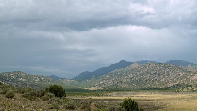 Time-lapse looking up towards Flat Top Mountain in Utah as clouds move through the sky.