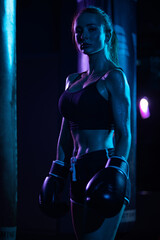 Fototapeta na wymiar Boxing. Sport concept. Girl sportsman muay thai boxer fighting in gloves in gym.