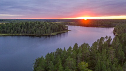 Northern nature. Panorama of the forest. Lake, forest, river. Beautiful landscape with lake and forest. Sunset and sunrise. Reflection of the forest in the water.