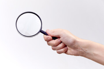 man holding magnifying glass on white background
