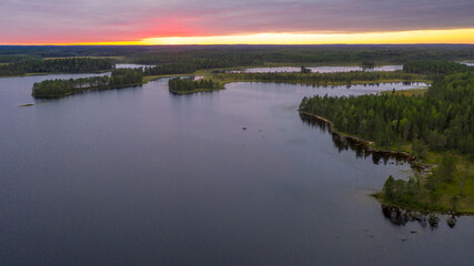 Northern nature. Panorama of the forest. Lake, forest, river. Beautiful landscape with lake and forest. Sunset and sunrise. Reflection of the forest in the water.