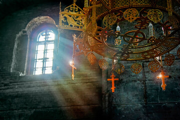 Rays of light in an ancient stone church. Sun's rays in dark stone temple. Lighting effects on the...