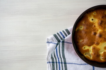 Homemade pear pie on a white table with pears in the background. Copy space.
