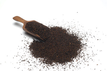 Dried black tea leaves in scoop isolated on white background.
