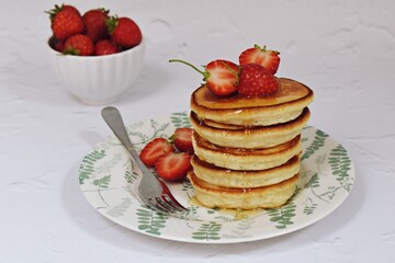 Dairy-free pancakes with strawberry and honey