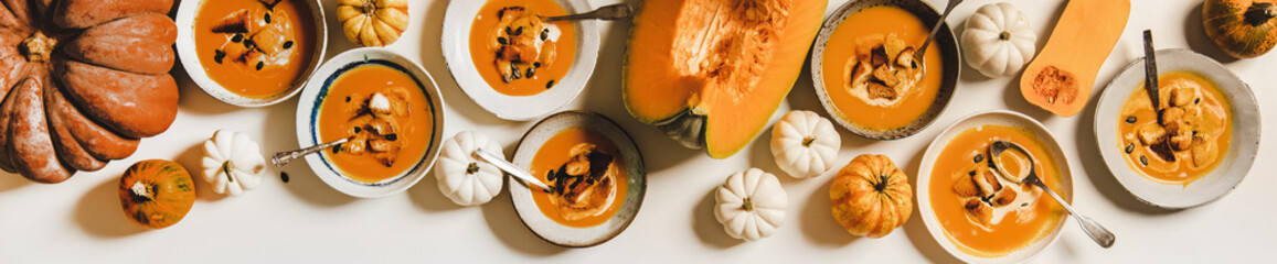 Pumpkin cream soup with cream, seeds and croutons, wide composition