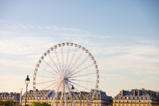 Beautiful shot of Ferris wheel on the background of the cloudy skies in pairs, France - Powered by Adobe