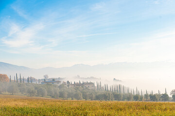 autumn landscape with fog enveloping the farm.