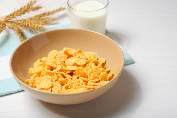  Crispy cornflakes with milk for breakfast on the table close-up.