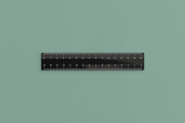 School black ruler on green background. Top view with copy space. Flat lay. Back to school concept.