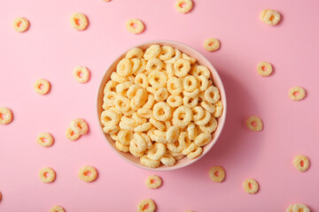 Corn rings in glaze for breakfast on a colored background.