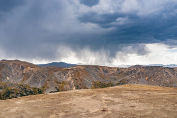 Developing thunderstorm with rain and virga over Rocky Mountains in Colorado, USA.