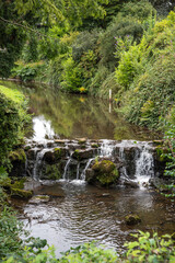 Fototapeta na wymiar Slow flowing water of narrow river in Buxton.