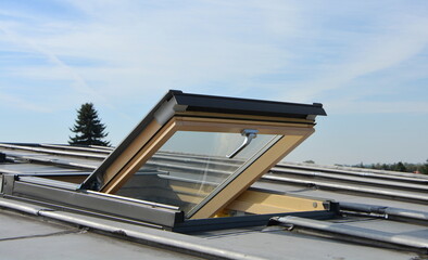 Roof windows mounted in a roof covered with an aluminum sheet.