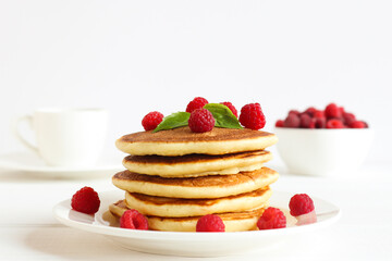 Delicious pancakes with raspberries and basil, selective focus. Tasty breakfast. Restaurant menu