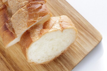 sliced French bread on wooden board