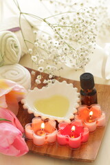 aroma candles and massage oil with towel