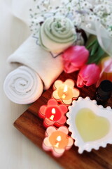 Obraz na płótnie Canvas aroma candles and massage oil with towel