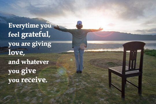 Inspirational Quote - Every Time You Feel Grateful, You Are Giving Love, And Whatever You Give Your Receive. With Woman Standing Alone, Hands Raised With Open Arms Against Light On Blue Lake View.