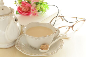 Light brown color glasses and book with milk tea for reading time