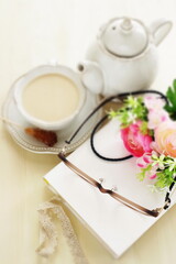 Light brown color glasses and book with milk tea for reading time