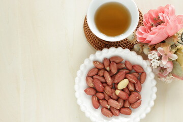 Fototapeta na wymiar Asian style peanut and Chinese tea with flower