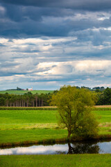 Fototapeta na wymiar Wisconsin farmland and pond with a dramatic sky in September