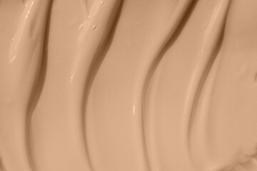 Beige nude liquid foundation smear, concealer texture smudge. Make up base drops, cream textured...