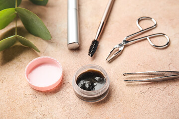 Henna and tools for eyebrows and eyelashes correction on color background, closeup