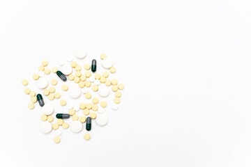 Capsules and tablets of white and yellow color. White background. Health concept