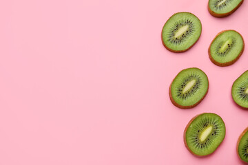Slices of fresh kiwi fruit on color background