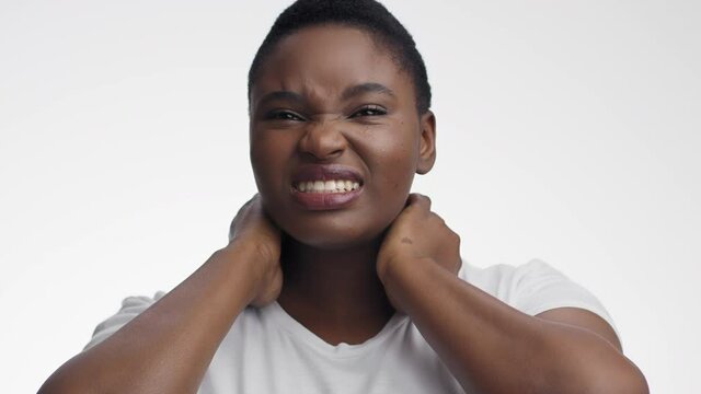 Young sick african american woman suffering from thyroid gland problem, touching her painful neck and grimacing