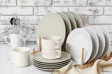 Set of clean dishes on table in kitchen