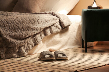 Female slippers on rug at home