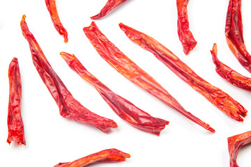 red hot dried peppers in a market basket on a white background