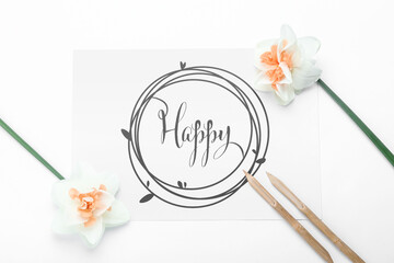 Paper with word HAPPY, dip pens and flowers on white background