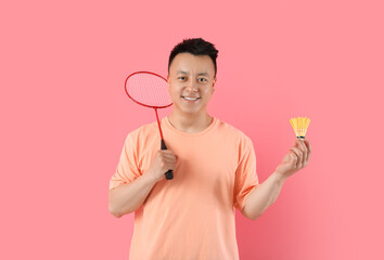 Sporty male badminton player on color background