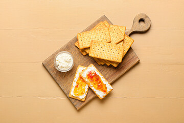 Delicious crackers with cottage cheese and jalapeno pepper jam on color wooden table