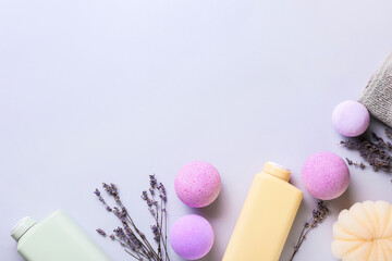 Composition with bath supplies, bombs and lavender flowers on light background