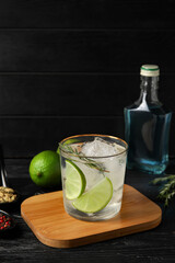 Glass of cold gin and tonic on dark background
