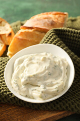 Bowl of tasty Caesar sauce on table