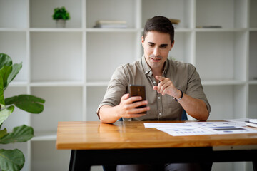 Video conference concept,Portrait of Happy handsome man or businessman in headset having web call on smartphone , working remotely from home office.