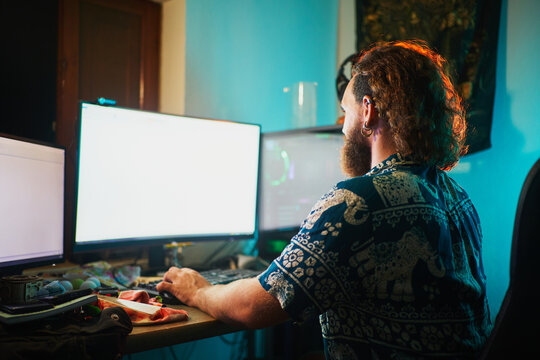 Unrecognizable Bearded Man Using Computer With 2 Screens