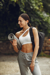 Woman in a sports clothes at the summer park