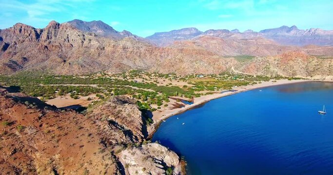 Strafe Flight of Valley Bay with Blue Water and Desert Mountain Background