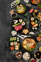 Japanese dishes and snacks on gray background.
