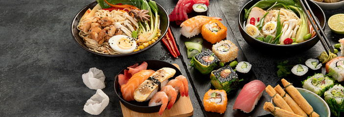Japanese dishes and snacks on gray background.