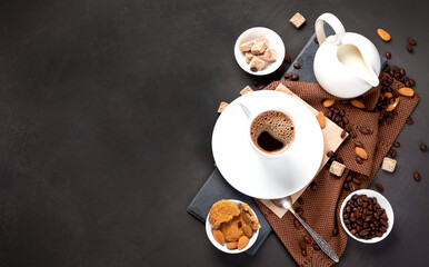 Coffee with snacks on black background.