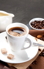 Coffee with snacks on black background.