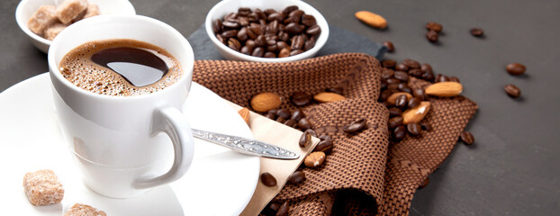 Coffee with snacks on black background.